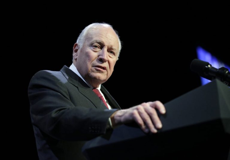 Former Vice President Dick Cheney speaks at a podium onstage.
