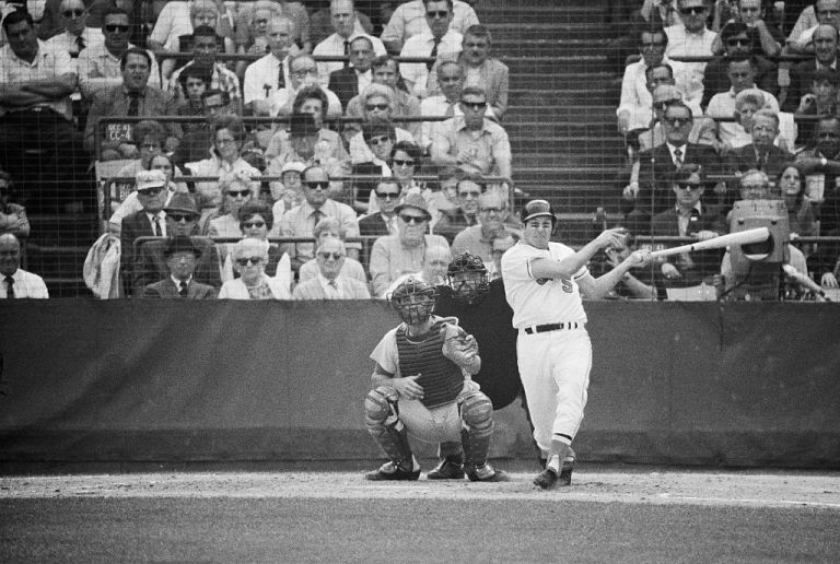 Orioles' Brooks Robinson connects for a home run in the 4th game of the World Series 10/14. Reds catcher is Johnny Bench and umpire is Bob Stewart.