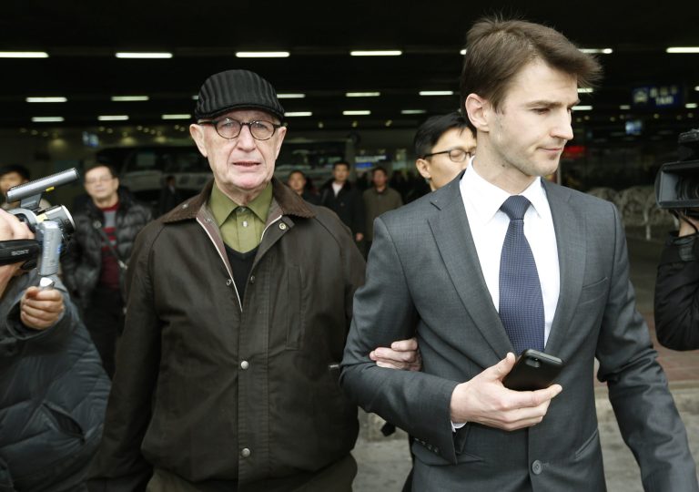 Australian missionary John Short, left, walks out from the airport terminal as he arrives at Beijing International Airport in Beijing, China, Monday, March 3, 2014. Short was deported from North Korea after he was detained for spreading Christianity in the country and apologized for his anti-state religious acts and requested forgiveness.  (AP Photo/Vincent Thian)
