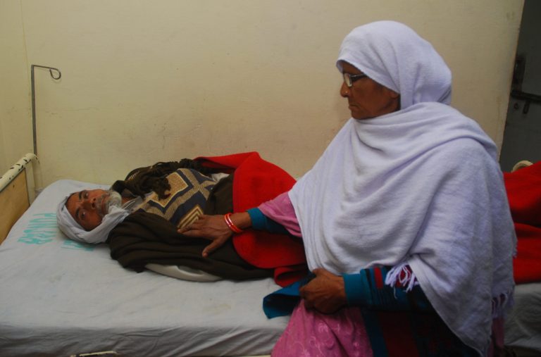   A Pakistani family member comforts Bahawal Shair, 70, who has been admitted to a local hospital after consuming a cough syrup, in Gujranwala, near Lahore, Pakistan on Saturday, Dec. 29, 2012. Pakistani authorities are investigating allegations that cough syrup has killed 33 people over the past three days, a government official said Saturday, the second time in recent months medicine is suspected of causing multiple deaths. (AP Photo/Ramiz Hassan)  