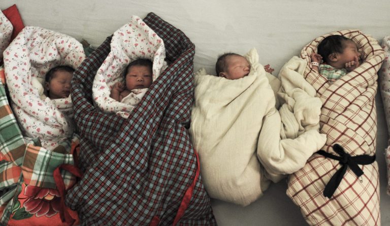   In this photo taken Wednesday, Jan. 25, 2012, newborn babies wait to be bathed at a hospital in Zouping county in east China's Shandong province. On Friday, June 15, 2012, China suspended three officials and apologized to a woman who was forced to undergo an abortion seven months into her pregnancy in a case that sparked a public uproar after graphic photos of the mother and her dead baby were circulated online. (AP Photo) CHINA OUT  