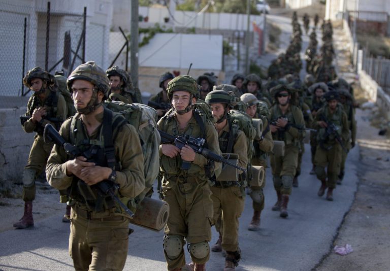 Israeli soldiers search for three missing teenagers during a military operation in the West Bank city of Hebron, Tuesday, June 17, 2014. Israeli security forces searched the West Bank, looking for three missing teenagers, including an American, who they fear have been abducted by Palestinian militants. (AP Photo/Majdi Mohammed)