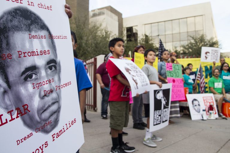 The activist group Puente, accompanied by family and friends facing deportation, holds a rally for deferred action for undocumented immigrants outside the U.S. Immigration and Customs Enforcement office in Phoenix on Friday, Nov. 13, 2014. (AP Photo/The Arizona Republic, Nick Oza)