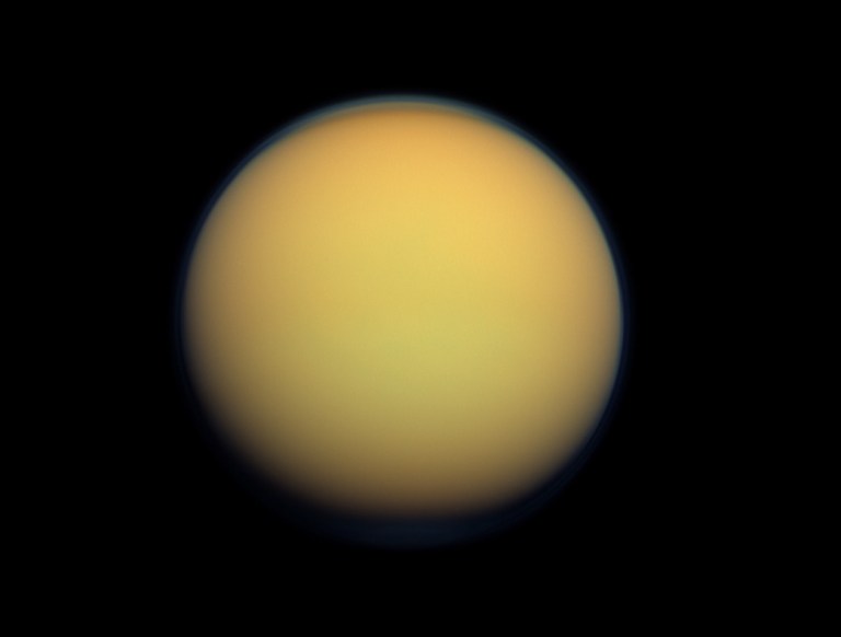   This image provided by NASA shows Saturn's largest moon Titan. A new study being released on Thursday, June 14,2012 suggests the presence of a hydrocarbon lake and several ponds near the equator of Titan, a surprise to scientists who thought lakes only existed at the poles. (AP Photo/NASA)  