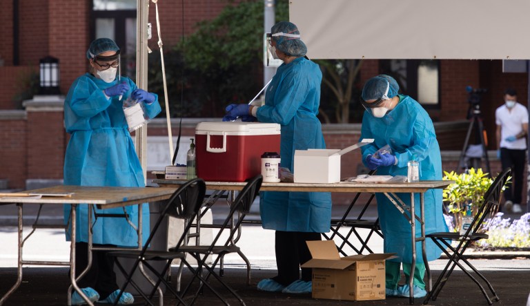 Healthcare workers prepare tests for COVID-19 at George Washington University Hospital in Washington, D.C.