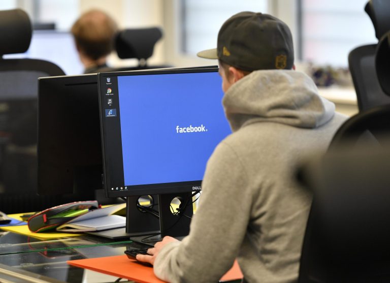 About 500 people control and delete Facebook content that doesn't meet the social media platform's standards at the company's new center in Essen, Germany, above, in late 2017. Refocusing users on content from family and friends has reduced the time they spend with Facebook, but will build a stronger company over the long term, founder and CEO Mark Zuckerbgerg told investors this week. (AP Photo/Martin Meissner)