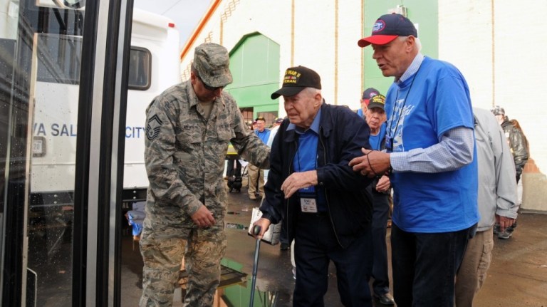 A World War II veteran and his guardian board a bus to depart Salt Lake City, Utah, on an honor flight trip to Washington, D.C., May 7, 2015. Nearly 50 veterans and their guardians made the trip to see the monument built in their honor. 