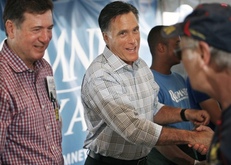 Republican presidential candidate Mitt Romney, center, greets a supporter as Virginia Republican Senate candidate George Allen, left, watches at Richmond International Raceway. (AP Photo)