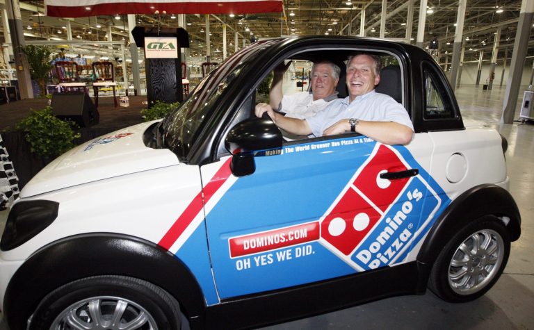 Former Mississippi Gov. Haley Barbour, left, and GreenTech Automotive chairman Terry McAuliffe take a quick spin in the plant after the unveiling of the company's new electric MyCar. (AP/Rogelio V. Solis)