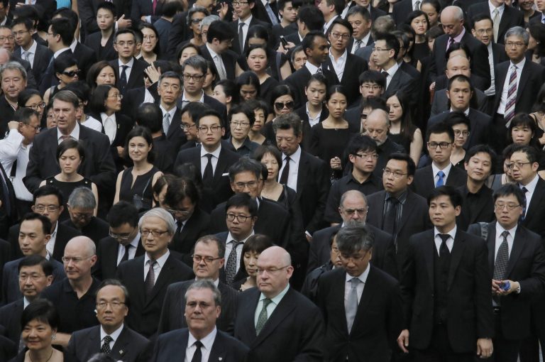 Hong Kong lawyers march in a Hong Kong street, Friday, June 27, 2014. Hundreds of Hong Kong lawyers dressed in black have marched in silence to protest a recent Beijing policy statement they say undermines the Asian financial hub's rule of law. (AP Photo/Vincent Yu)