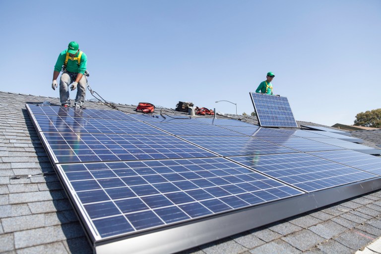 In this undated photo provided by SolarCity, workers install solar panels on the roof of a home. SolarCity will begin offering loans to homeowners for rooftop solar systems, a move that analysts say could reshape the market for rooftop solar and propel its rapid adoption. (AP Photo/Courtesy SolarCity)