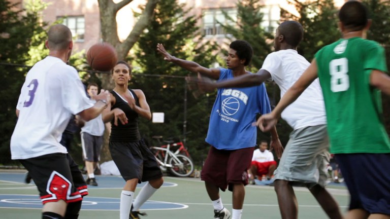 This film publicity image released by Doin' It In The Park, LLC shows female basketball player Niki Avery, second left, playing basketball in the Spanish Harlem section of New York during filming of the documentary 