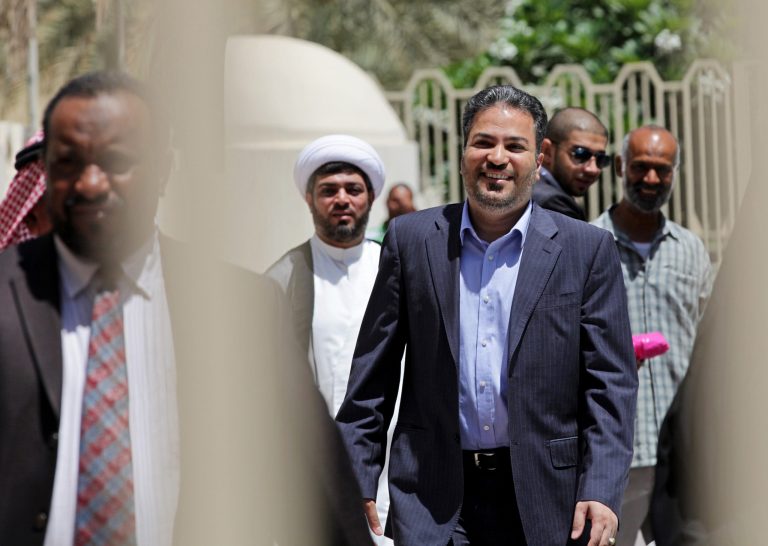 Khalil al-Marzooq, a senior member of the largest opposition group in Bahrain, Al-Wefaq, smiles at the courthouse in Manama, Bahrain, Wednesday, June 25, 2014. A judge acquitted al-Marzooq of all charges against him, including supporting terrorist acts. (AP Photo/Hasan Jamali)