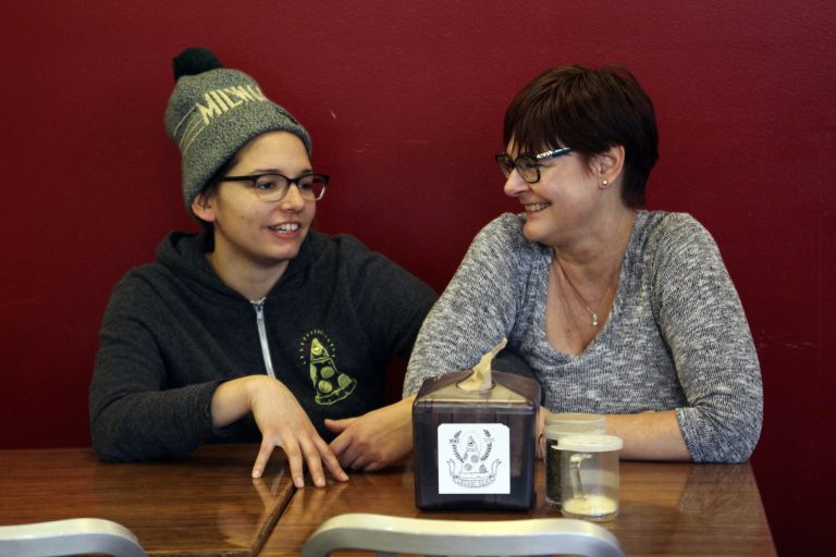 In this Jan. 9, 2017, photo, Andrea Ledesma, left, talks with her mother, Cheryl Romanowski, at Classic Slice pizza restaurant, where Ledesma works, in Milwaukee. Ledesma, 28, says her parents owned a house and were raising kids by her age. Not so for her, even though she has a college degree. (AP Photo/Carrie Antlfinger)