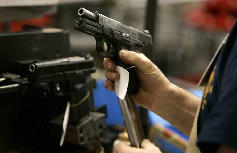 Dennis Roberts loads a magazine into the grip of a model 9VE pistol, which was manufactured for the U.S. Military for use by the Afghanistan National Police and Border Patrol, while test firing prior to shipping at the Smith & Wesson factory in Springfield, on Dec. 19, 2006. Smith & Wesson said it will stop selling new versions of semiautomatic pistols in California because of a law requiring the weapons to stamp identifying information onto bullet casings when the guns are fired. (AP Photo/Charles Krupa)