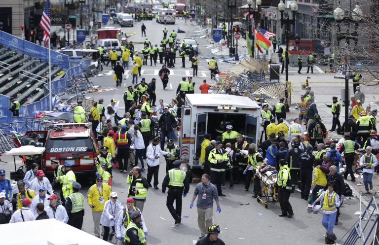 Medical workers aid injured people at the finish line of the 2013 Boston Marathon following an explosion in Boston, Monday, April 15, 2013. (AP Photo/Charles Krupa)