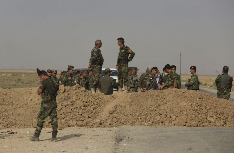 Kurdish peshmerga fighters stand guard on the front line with the Islamic State group, as they patrol in Rabia, northwestern Iraq, Wednesday, Oct. 1, 2014. Iraqi Kurdish fighters on the front lines of battle say they have yet to receive the heavy weapons and training pledged by the United States and nearly a dozen other countries to help them push back the Sunni militants. Without more sophisticated weaponry, the Kurdish fighters, known as peshmerga, have had to rely on aging arms like the Soviet-era cannons, a centerpiece of the offensive Tuesday to retake Mahmoudiyah. (AP Photo/Hadi Mizban)