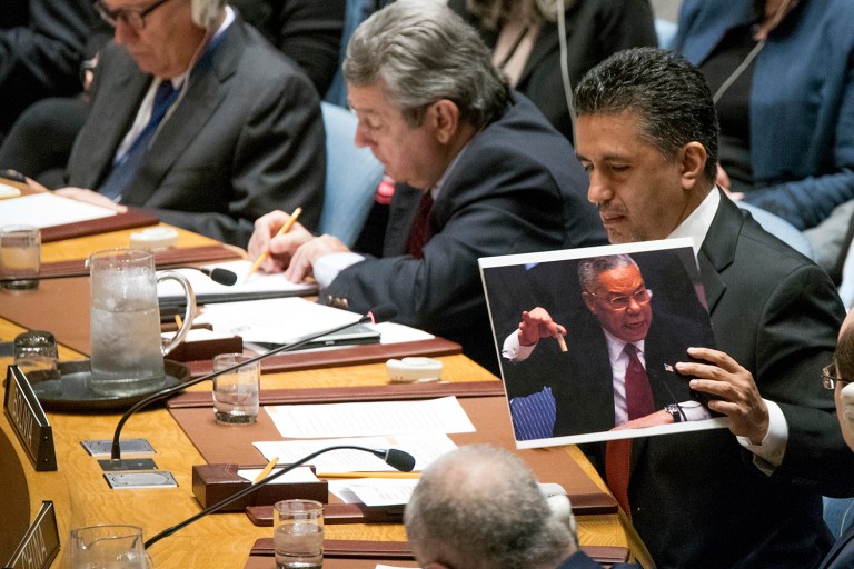 Bolivian Ambassador to the United Nations Sacha Sergio Llorenti Soliz holds a photo of former U.S. Secretary of State Colin Powell holding up a vial that he described as one that could contain anthrax, during a Security Council meeting on the situation in Syria, Friday, April 7, 2017 at United Nations headquarters. (AP Photo/Mary Altaffer)