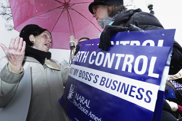 Demonstrators on opposite sides of the issue argue during a rally outside of the U.S. Supreme Court during oral arguments in Sebelius v. Hobby Lobby March 25, 2014 in Washington. (Photo by Chip Somodevilla/Getty Images)