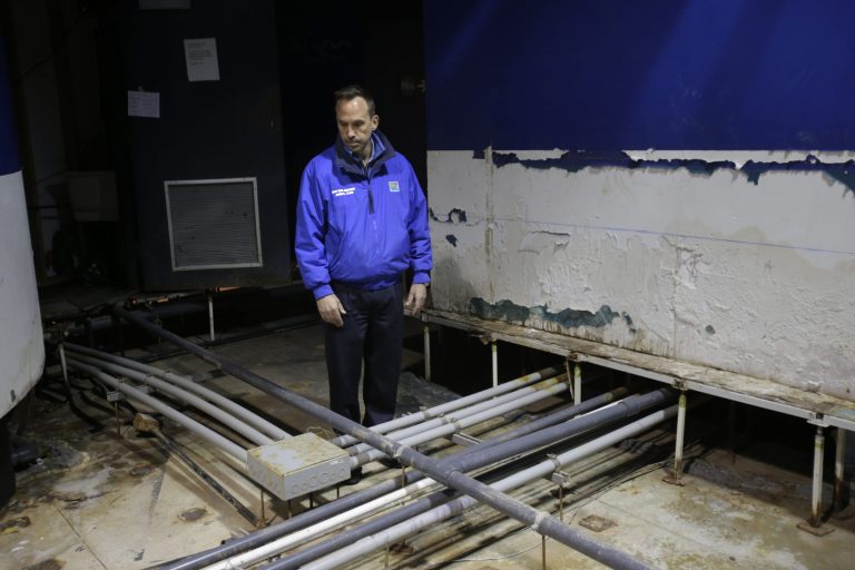 Director of the New York Aquarium, John Dohlin, looks around an exhibit ruined during Superstorm Sandy at the aquarium in Coney Island, New York, Monday, March 25, 2013. (AP Photo/Seth Wenig)