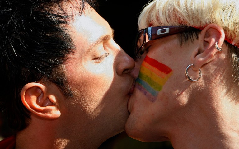 FILE - In this Saturday, Aug. 12, 2006 file photo, Gay pride parade participants kiss in the streets of Tallinn, Estonia. Estonia's Parliament narrowly passed legislation to legalize gay partnerships on Thursday, Oct. 9, 2014, making it the first former Soviet republic to do so. (AP Photo/AFI, Toms Kalnins, File)