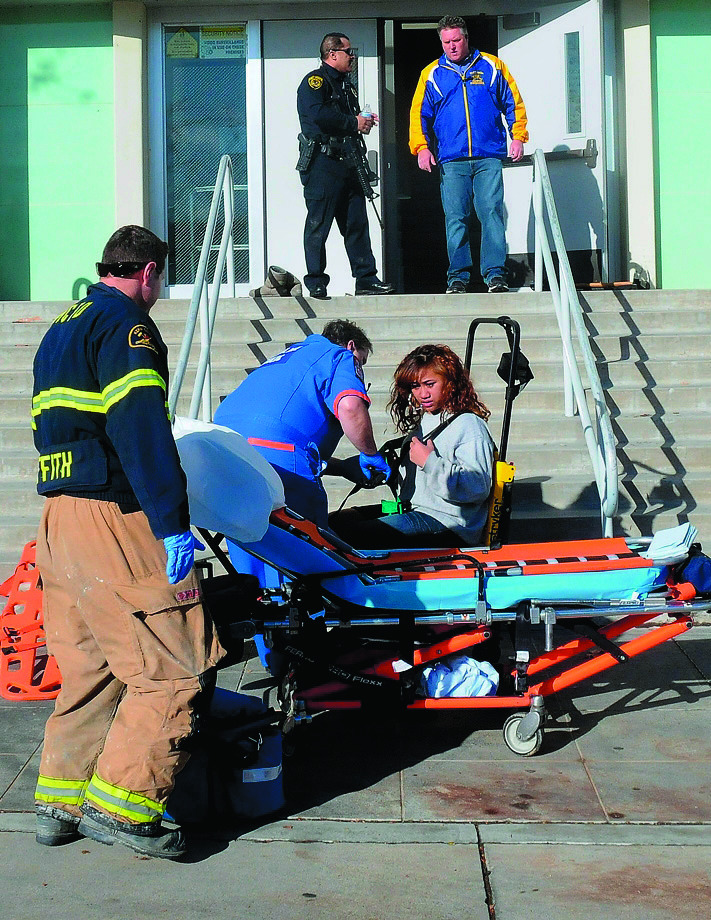 This image provided by the Taft Midway Driller/Doug Keeler shows paramedics assisting a student wounded during a shooting Thursday Jan. 10, 2013 at San Joaquin Valley high school in Taft, Calif. Authorities said a student was shot and wounded and another student was taken into custody. (AP Photo/Taft Midway Driller, Doug Keeler) MANDATORY CREDIT