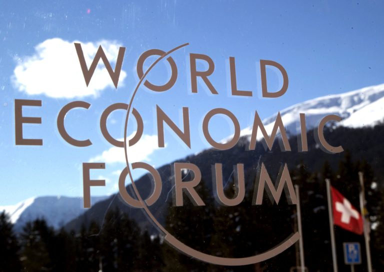 The logo of the Forum is seen through a window with the alps in the background during the World Economic Forum in Davos, Switzerland, on Jan. 22. At the forum, Ahmed Shihab-Eldin, host of Huffington Post's 