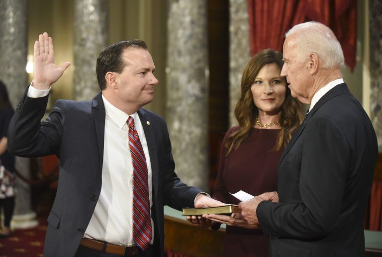 Vice President Joe Biden administers the Senate oath of office to Sen. Mike Lee, R-Utah as his wife, Sharon Lee, holds the Bible during a a mock swearing in ceremony in the Old Senate Chamber on Capitol Hill in Washington, Tuesday, Jan. 3, 2017, as the 115th Congress begins. (AP Photo/Kevin Wolf)