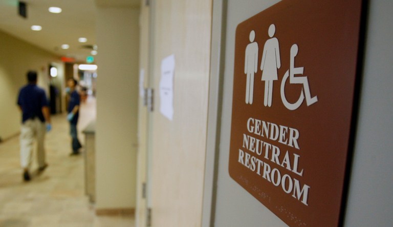 A sign marks the entrance to a gender-neutral restroom. President Trump's nominee to a federal judgeship in Texas described transgender children as involved in 