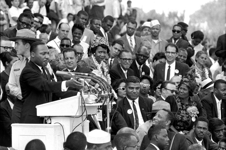 Rev. Dr. Martin Luther King Jr., head of the Southern Christian Leadership Conference, speaks to thousands during his 