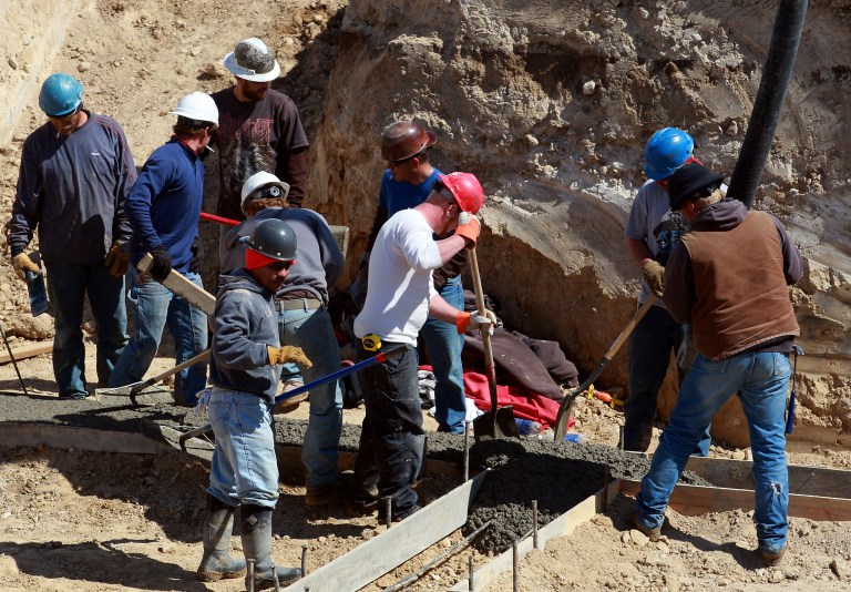 Workers from Alme Concrete Construction pour a concrete footer for the foundation of a new home on Friday, April 19, 2013 in the Centennial Hills subdivision in Casper, Wyo. (AP Photo/The Casper Star-Tribune, Alan Rogers)