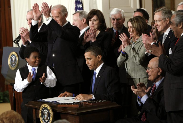 In this March 23, 2010, file photo, President Barack Obama is applauded after signing the health care bill in the East Room of the White House in Washington. (AP Photo/Charles Dharapak, File)