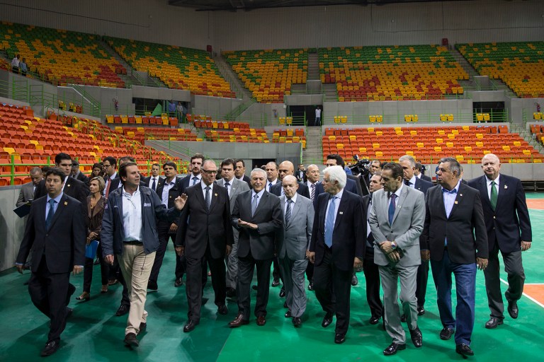 Brazil's interim President Michel Temer, center, walks with officials during a visit to the Olympic Park in Rio de Janeiro, Brazil. A panel of WHO experts found that the risk of getting the Zika virus will be low at the summer Olympics in Rio de Janeiro in August. (AP Photo/Felipe Dana)
