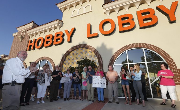 Rev. Bruce Prescott, left, leads a vigil outside a Hobby Lobby store in Edmond, Okla. (AP/Sue Ogrocki)