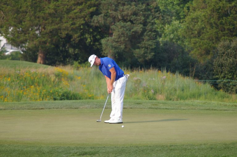  Hunter Mahan sinks a birdie putt on the 18th hole Friday at Congressional to take a two-stroke lead in the AT&amp;T National. Photo by Kevin Dunleavy 