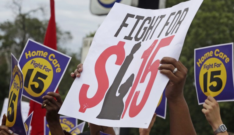 In this Sept. 14, 2014, file photo, protesters participate in a rally on Chicago's south side as labor organizers escalate their campaign raise the minimum wage for employees to $15 an hour.