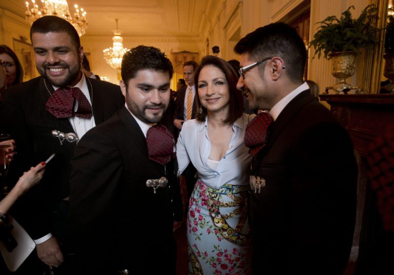 Singer Gloria Estefan, center, from Miami, with members of Mariachi band, Los Gallos Negros, at a celebration of Cinco de Mayo in the East Room of the White House in Washington, Monday, May 5, 2014. (AP Photo/Pablo Martinez Monsivais)
