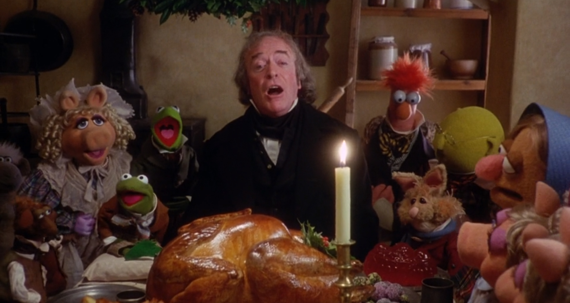 Ebenezer Scrooge (Michael Caine) in the Cratchit house