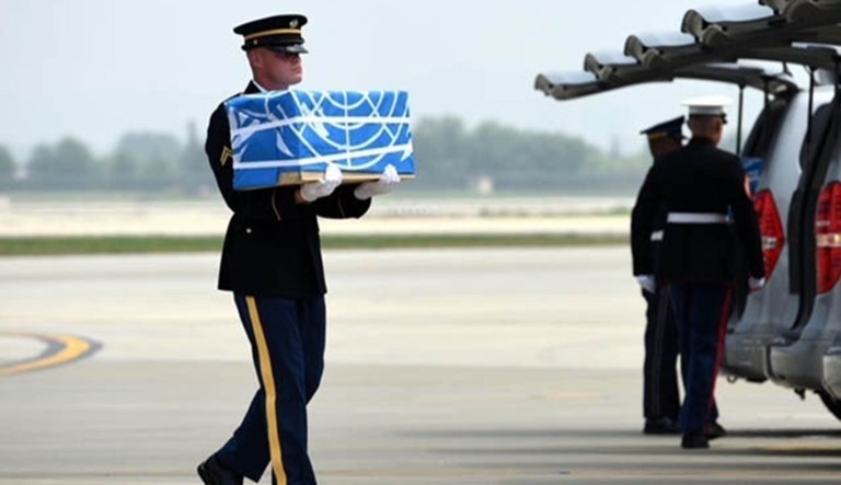 A United Nations Honor Guard member carries remains during a dignified return ceremony at Osan Air Base, South Korea, Friday. 