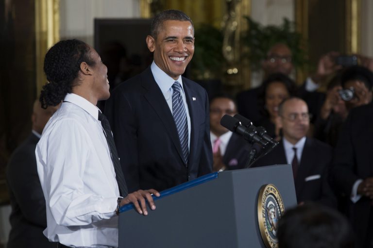 President Barack Obama laughs as he is introduced by Christian Champagne, 18, a senior at Hyde Park Career Academy in Chicago, during an event in the East Room of the White House in Washington, Thursday, Feb. 27, 2014, to promote his 