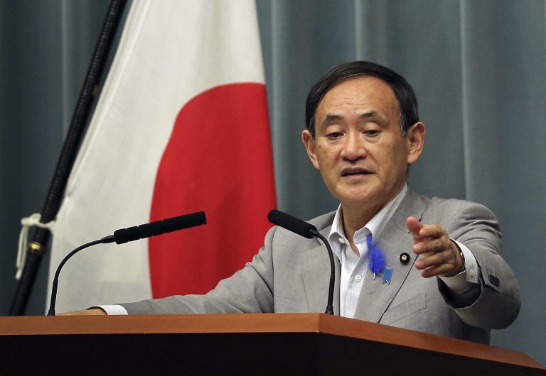 Japan's Chief Cabinet Secretary Yoshihide Suga answers a question during a press conference in Tokyo, Friday, July 4, 2014. Japan took a tentative step toward improved relations with North Korea on Friday by agreeing to lift some of its sanctions in response to the North's decision to re-open a probe into the fate of at least a dozen Japanese believed to have been abducted by North Korean agents decades ago.(AP Photo/Eugene Hoshiko)