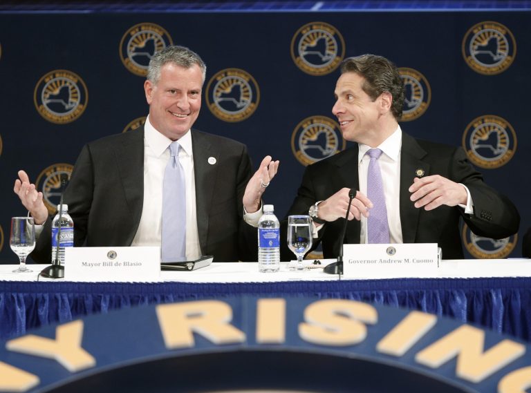 New York City Mayor Bill de Blasio, left, and New York Gov. Andrew Cuomo talk during the NY Rising Spring Conference on Wednesday, April 23, 2014, in Albany, N.Y. (AP Photo/Mike Groll)