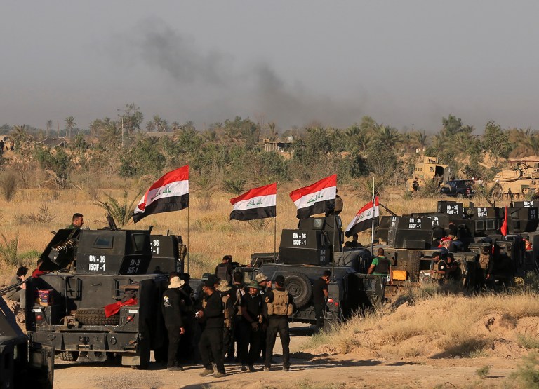 A wave of bombings claimed by the Islamic State group targeted commercial areas in and around Baghdad on Monday, killing more than 20 people in attacks that came as Iraqi troops poised to recapture Fallujah. (AP Photo/Khalid Mohammed)