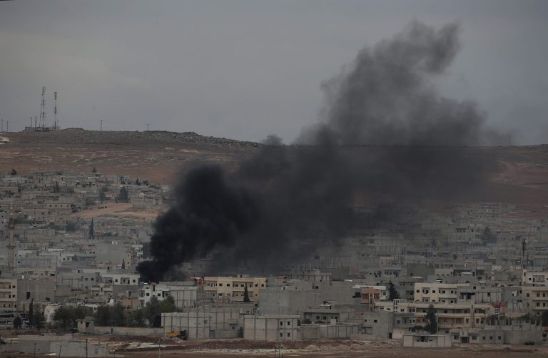 Smoke from a fire rises following a strike in Kobani, Syria, during fighting between Syrian Kurds and the militants of Islamic State group, as seen from a hilltop on the outskirts of Suruc, at the Turkey-Syria border, Sunday, Oct. 19, 2014. Kobani, also known as Ayn Arab, and its surrounding areas, has been under assault by extremists of the Islamic State group since mid-September and is being defended by Kurdish fighters. (AP Photo/Lefteris Pitarakis)