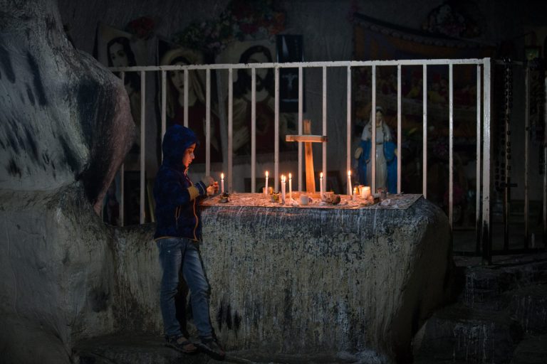 A Iraqi Christian boy lights candles inside a shrine in the grounds of Mazar Mar Eillia (Mar Elia) Catholic Church, that has now become home to hundreds of Iraqi Christians who were forced to flee their homes as the Islamic State advanced earlier this year, on December 12, 2014 in Erbil, Iraq. (Photo by Matt Cardy/Getty images)