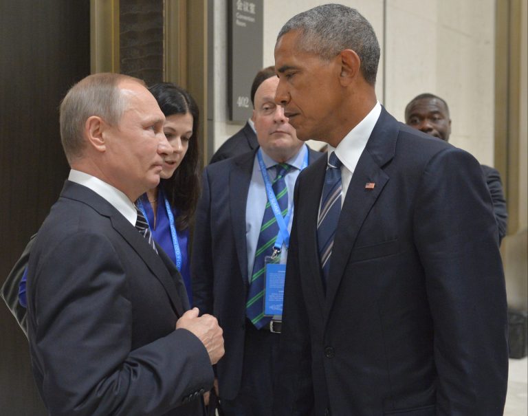 Russian President Vladimir Putin, left, speaks with President Barack Obama.