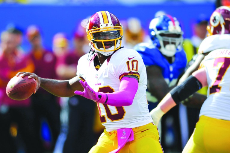 Kathy Willens/AP
Rookie quarterback Robert Griffin III, who leads the NFL in yards per carry, has led the Redskins to 28.7 points a game this season.