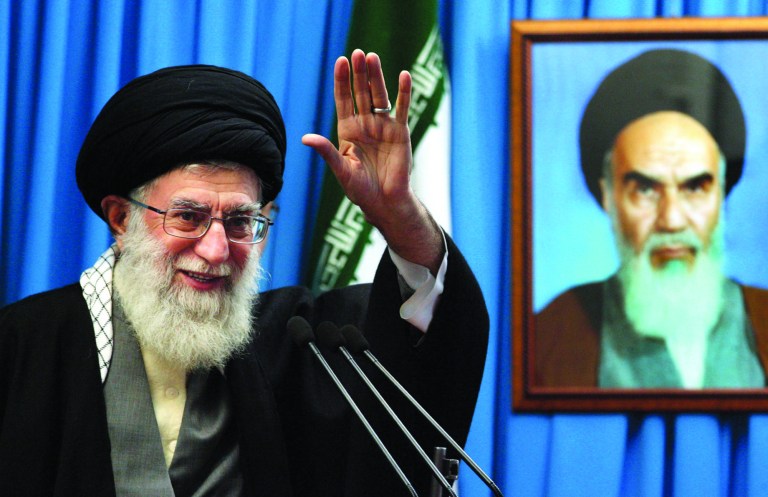 FILE - In this Friday, Feb. 3, 2012 file photo released by an official website of the Iranian supreme leader's office, Iranian supreme leader Ayatollah Ali Khamenei waves to the worshippers, in front of a portrait of the late revolutionary founder Ayatollah Khomeini, before he delivers his Friday prayers sermon, at the Tehran University campus, Iran. Iran's supreme leader Thursday, Feb. 7, 2013 strongly rejected proposals for direct talks with United States, apparently quashing suggestions for a breakthrough dialogue on the nuclear standoff and potentially other issues.(AP Photo/Office of the Supreme Leader, File)