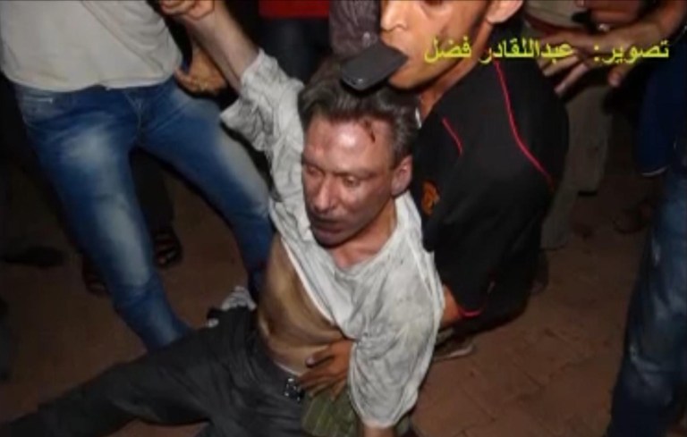 This still image included in a video obtained by the Associated Press from Fahd al-Bakoush, a freelance videographer and activist, which has been authenticated based on its contents and other AP reporting, shows the body of U.S. Ambassador Chris Stevens being moved by Libyan civilians trying to rescue him after gunmen and protesters rampaged through the U.S. consulate in Benghazi, Libya, Tuesday, Sept. 11, 2012. The group of Libyans had stumbled across Stevens' seemingly lifeless form inside a dark room and didn't know who he was, only that he was a foreigner, al-Bakoush and two other witnesses told the AP. The Arabic script in the photo translates into English as, 