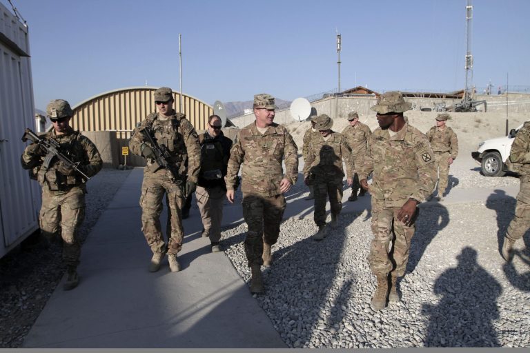 U.S. Major General James C. McConville, center, walks with troops at a base in Laghman province, east of Kabul, Afghanistan, on Dec. 24. (AP Photo/Rahmat Gul)